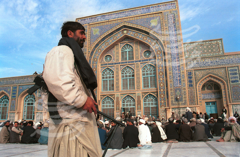 a guard patrols the square in front of the Jamee mosque in Herat, Afghanistan
