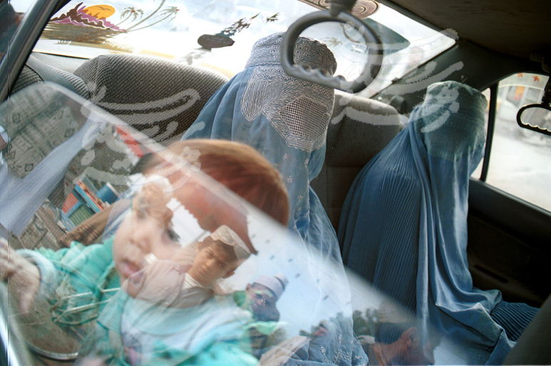 Veiled women in a taxi cab in Afghanistan